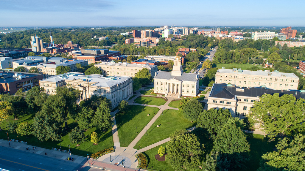 An aerial photograph of the Pentacrest at the University of Iowa in the morning looking west